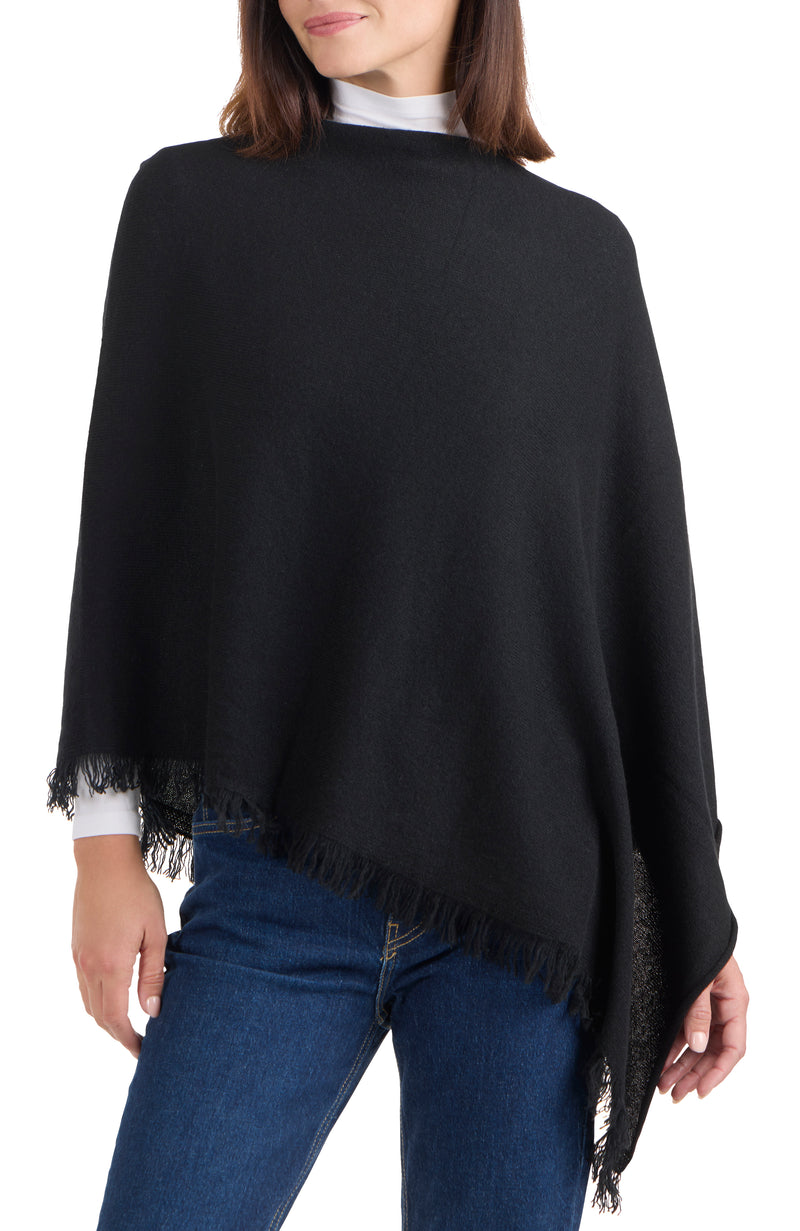 model wearing CASHMERE FRINGE JERSEY ASYMMETRICAL PONCHO in black front