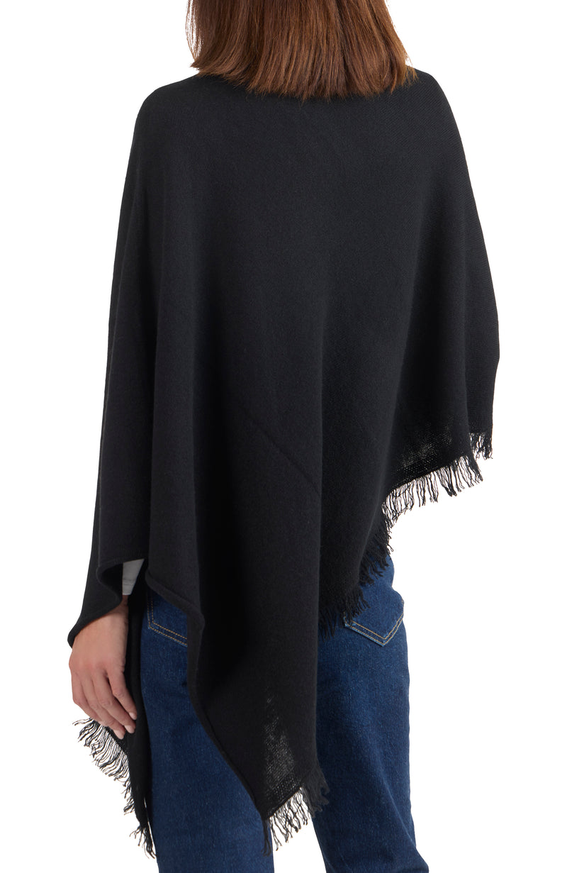 model wearing CASHMERE FRINGE JERSEY ASYMMETRICAL PONCHO in black back