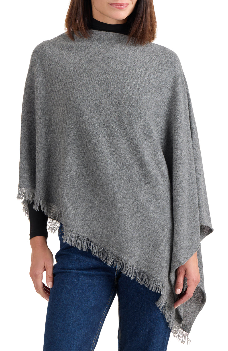 model wearing CASHMERE FRINGE JERSEY ASYMMETRICAL PONCHO in medium grey front