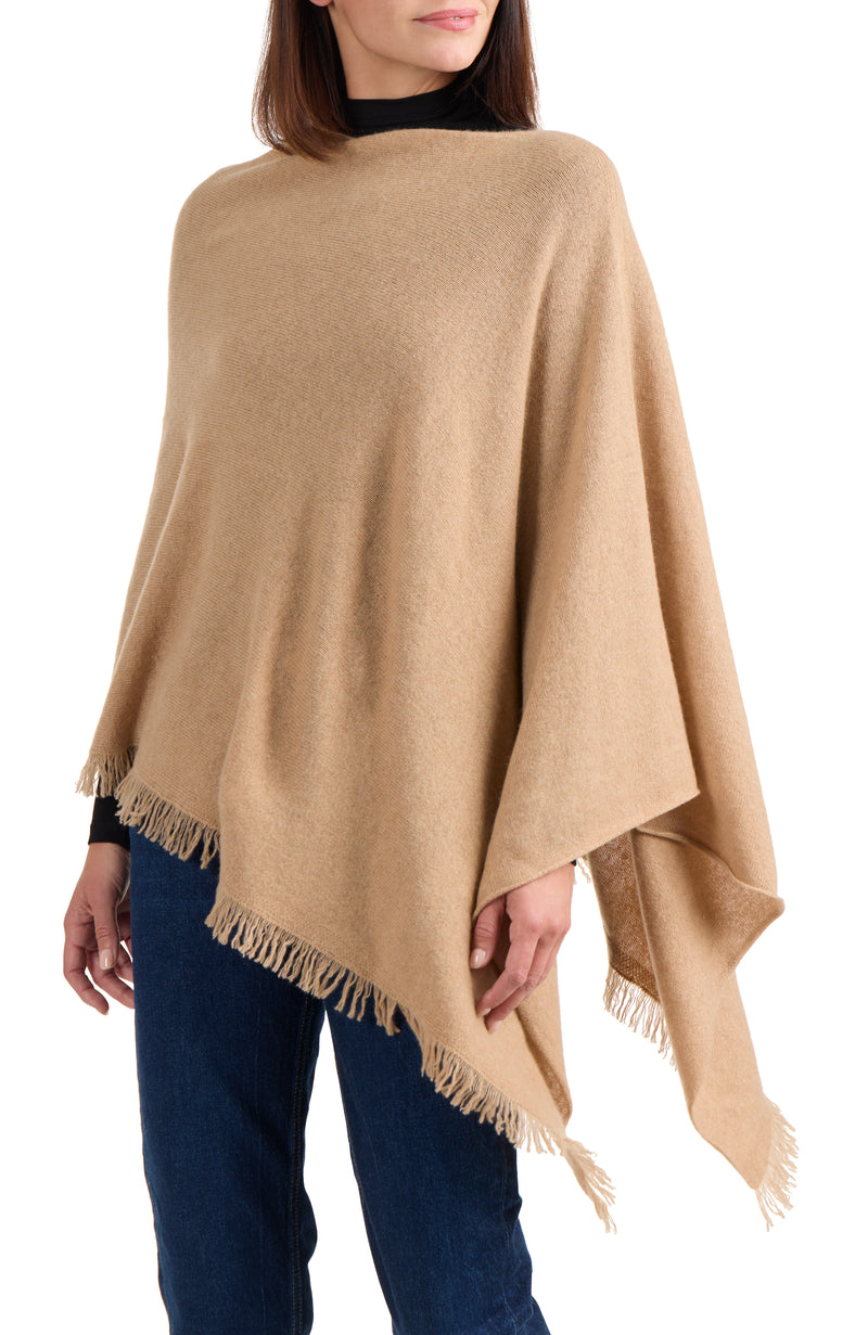 model wearing CASHMERE FRINGE JERSEY ASYMMETRICAL PONCHO in camel front