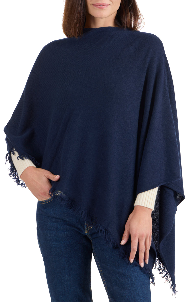 model wearing CASHMERE FRINGE JERSEY ASYMMETRICAL PONCHO in navy front