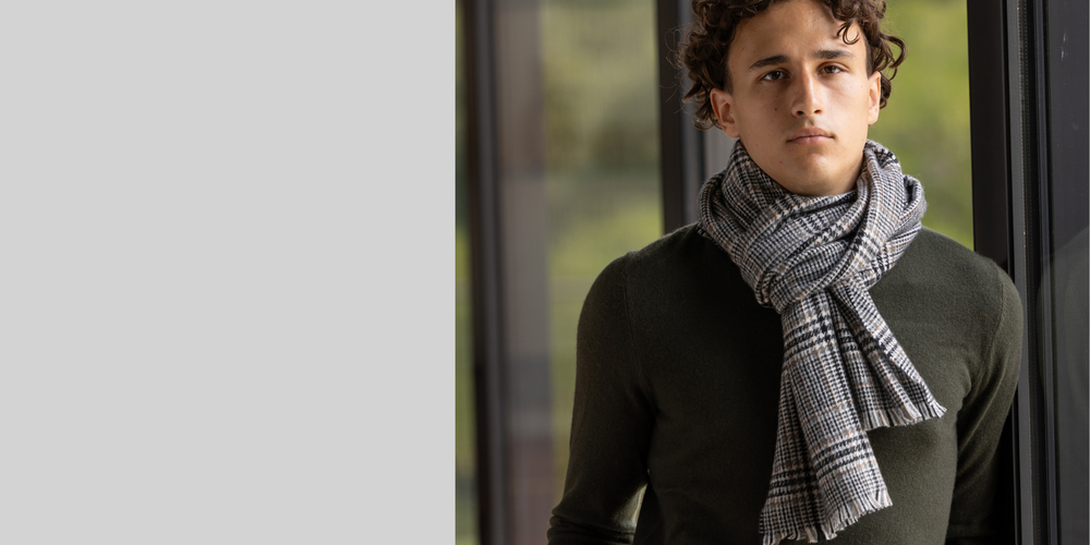 young male model wearing plaid cashmere scarf tied around neck