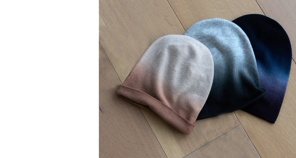 Wear a work of art. Cashmere dip dye beanie hats in tan, black and navy